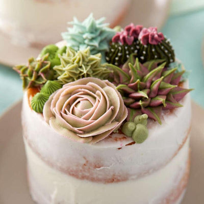 Floral buttercream icing decorations on cake